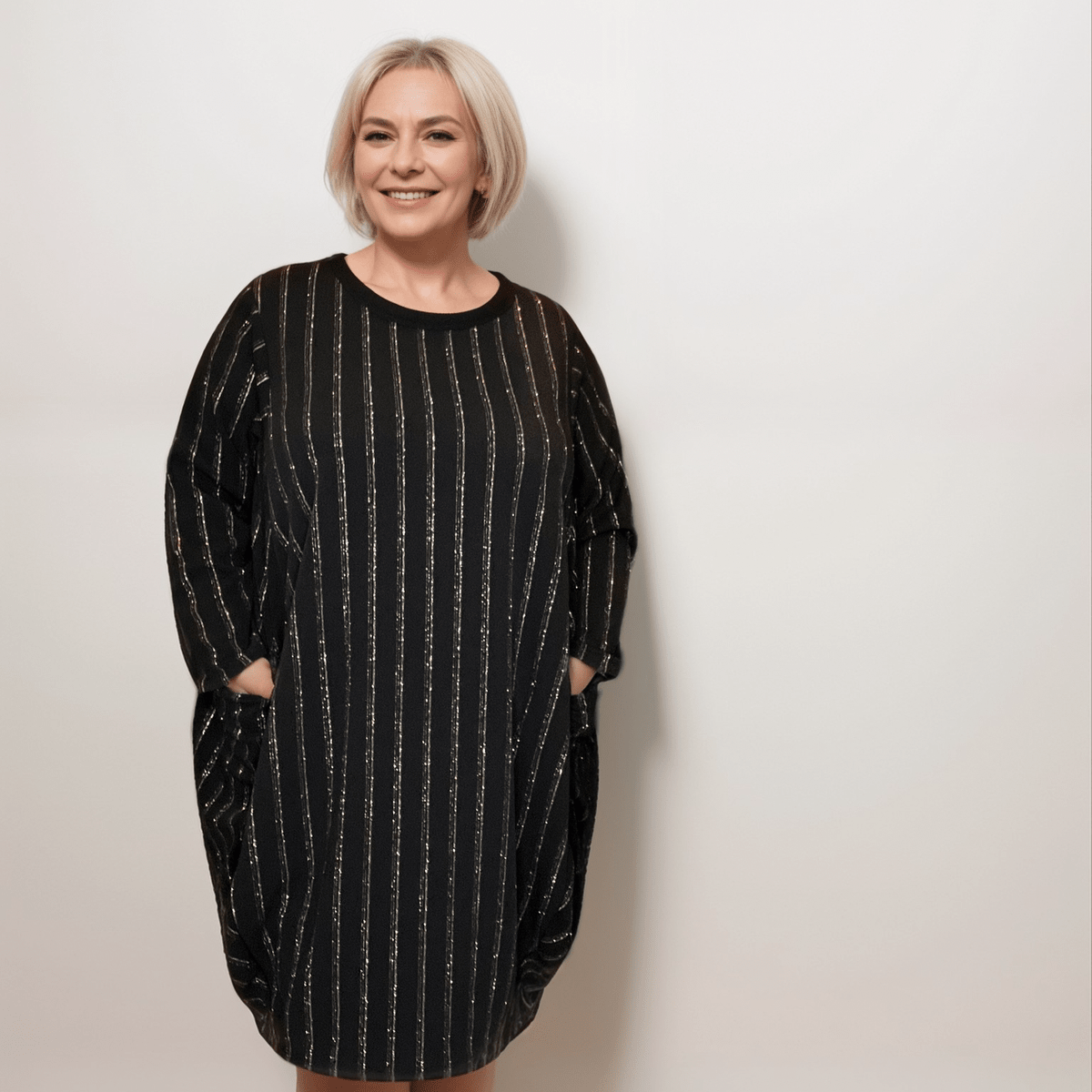 Black striped oversized dress featuring pockets, perfect for casual wear.
