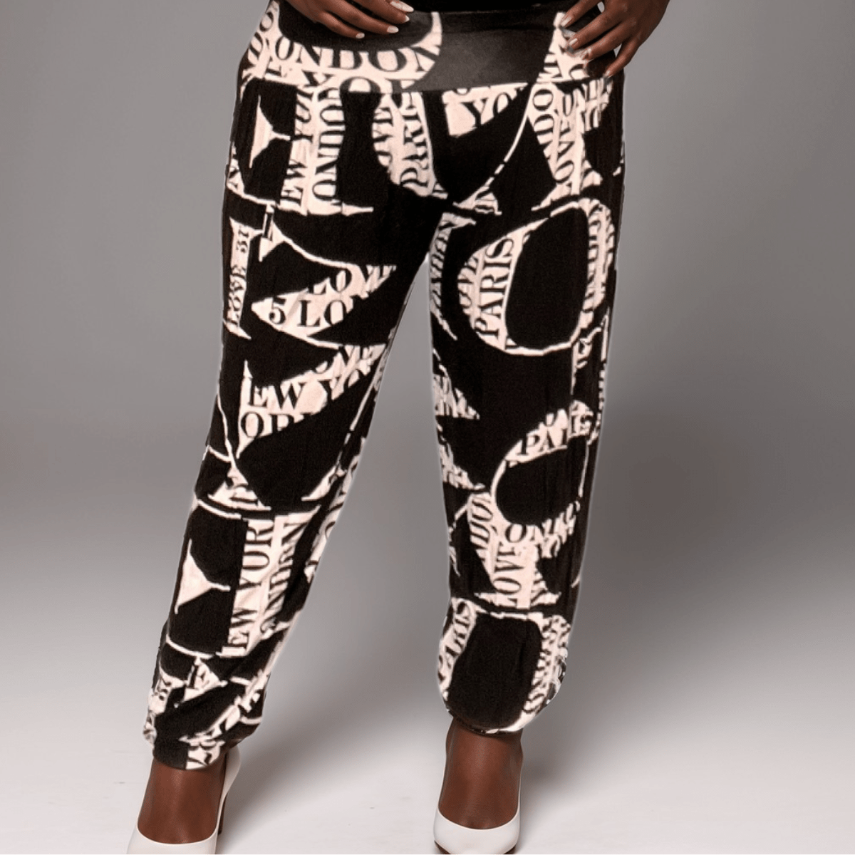 Fashionable black and white printed joggers featuring city names like London and Paris.