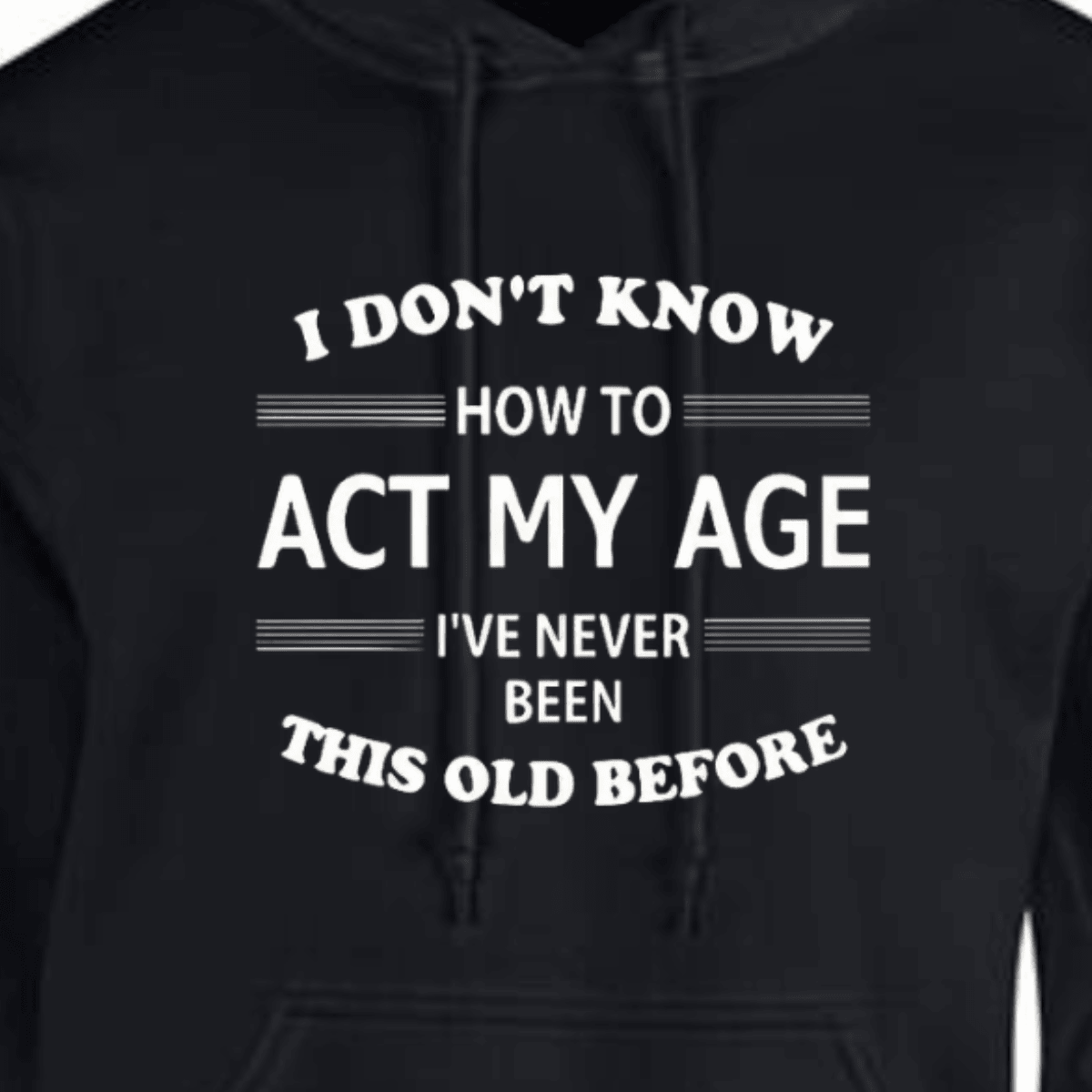 Act My Age hoodie featuring humorous text about aging in white on a black background.