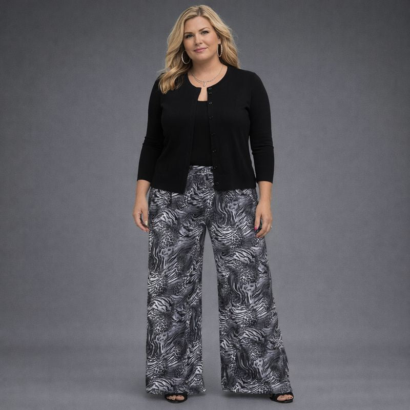 Black cardigan paired with stylish black and white patterned wide-leg pants.