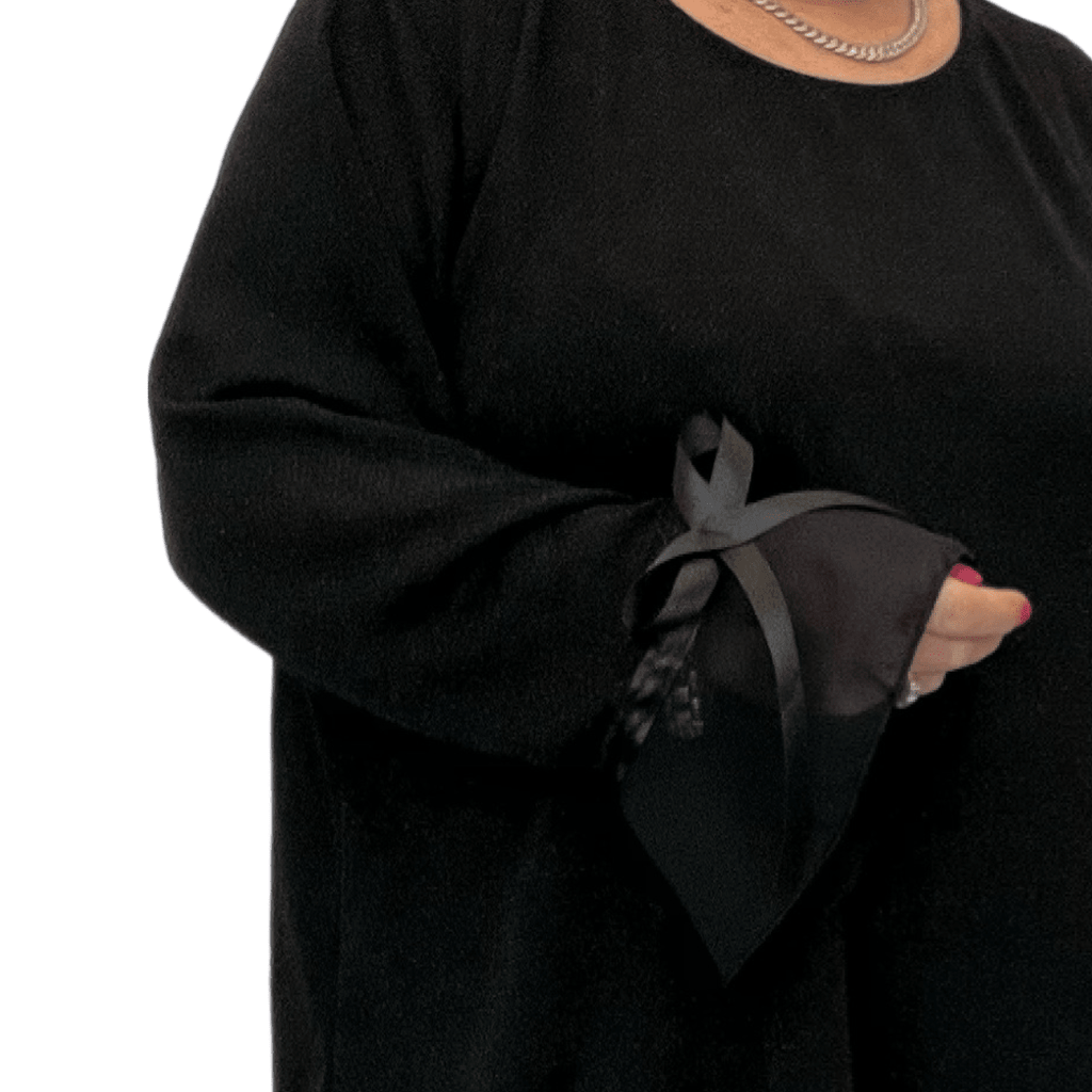 Black Plus Size Top featuring elegant sheer sleeves with ribbon detail.