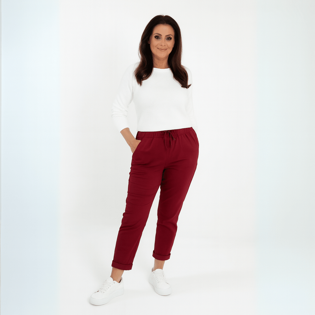 Comfortable burgundy jogger pants featuring an elastic waistband, paired with a white top.