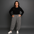 Black and white checkered pants featuring a relaxed fit and elastic cuffs.