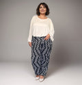 Comfortable plus-size outfit featuring a white top and patterned black pants.