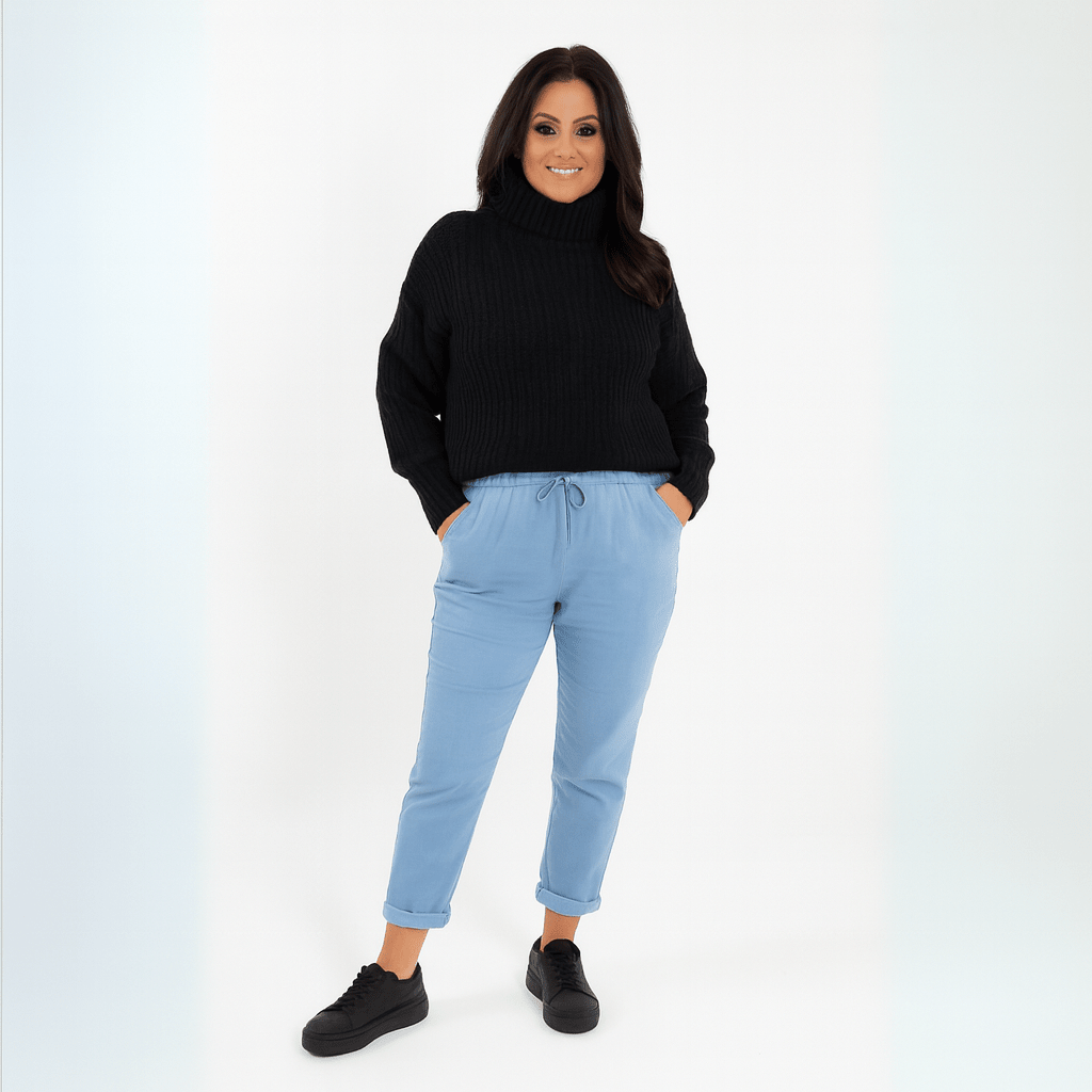 Cozy black turtleneck sweater paired with light blue jogger pants for a stylish look.
