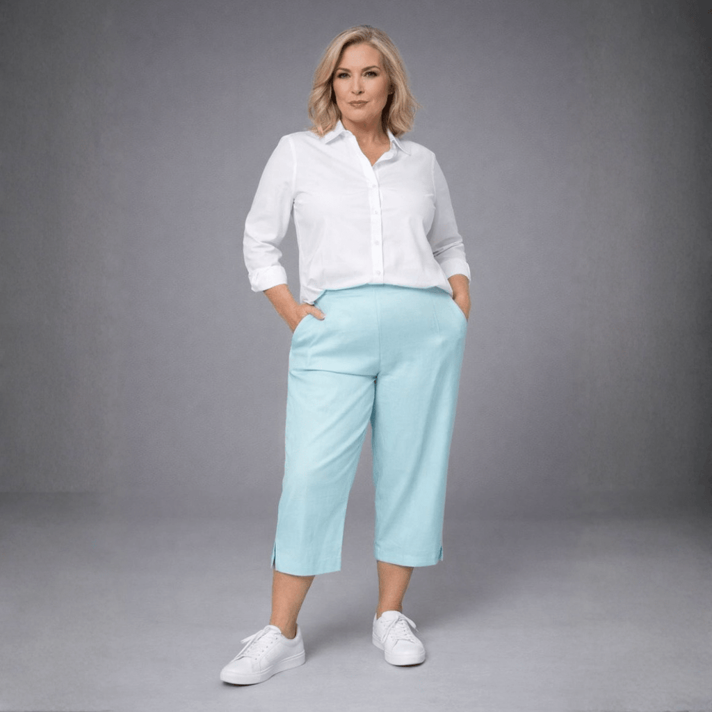 Light blue linen culottes featuring side pockets, paired with a white button-up shirt.