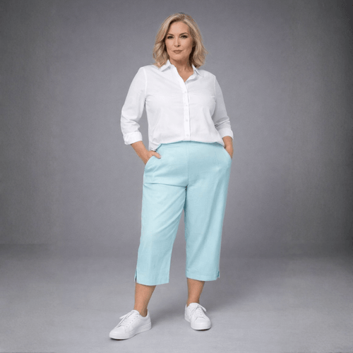 Light blue linen culottes featuring side pockets, paired with a white button-up shirt.