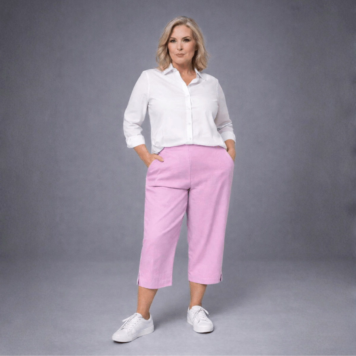 Pink Cropped Pants featuring a relaxed fit and side pockets, styled with a white blouse.