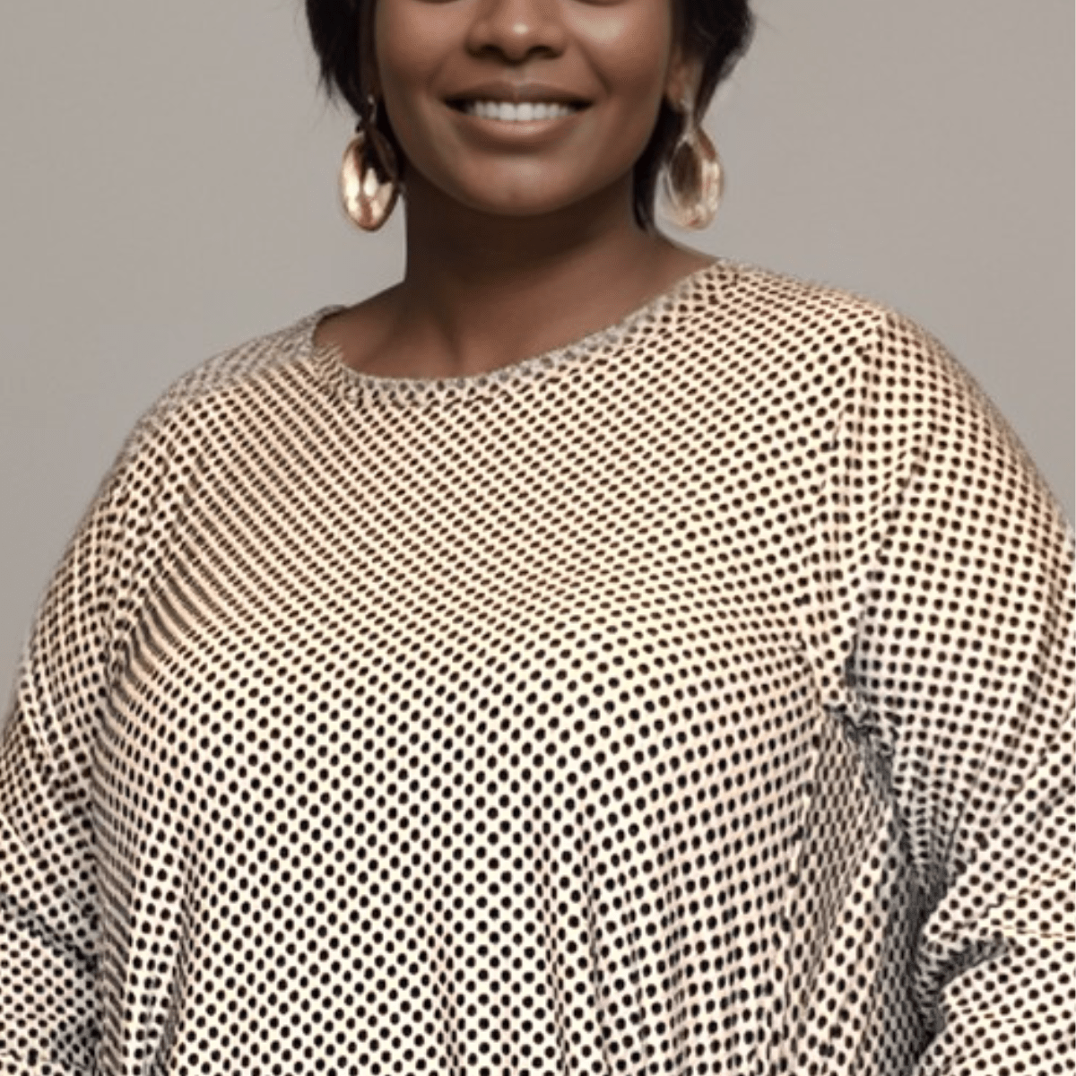Stylish mesh top featuring a unique pattern and relaxed fit.